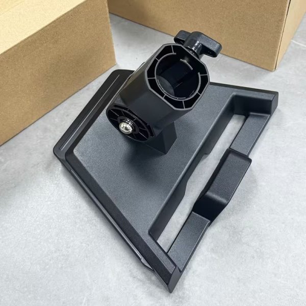 Starlink V4 pipe adapter and round plate on a flat surface